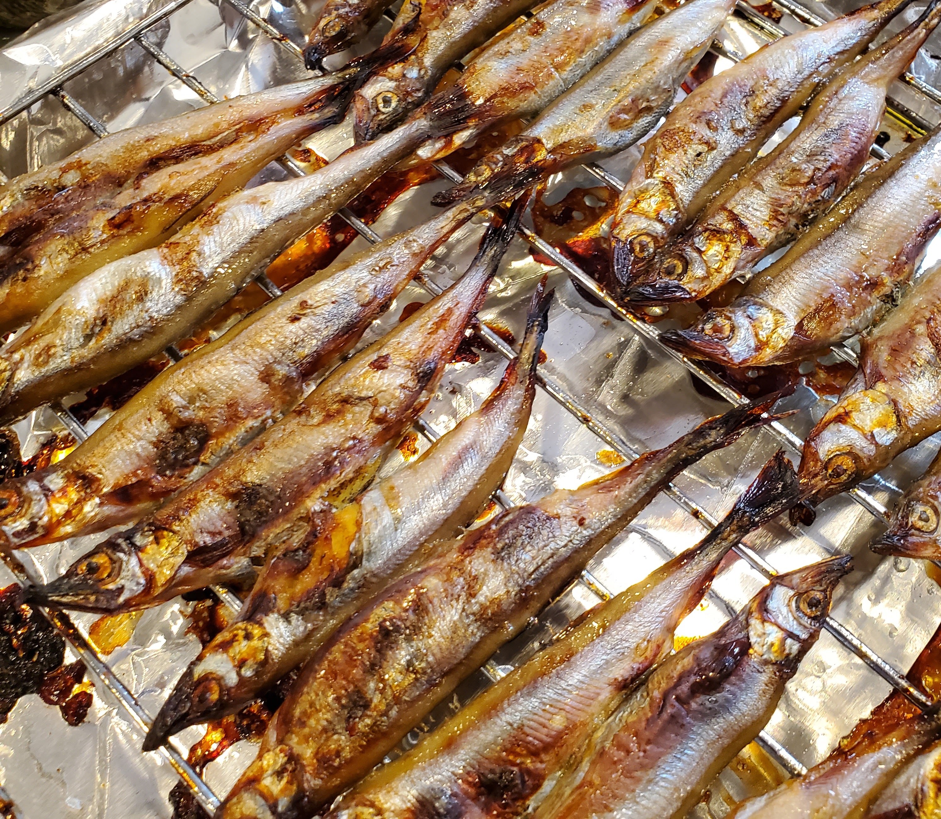 Small fish grilling on a rack